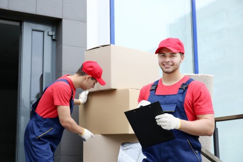 Team member carrying boxes from van