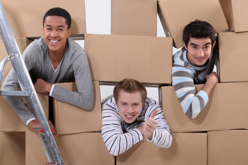 Team of movers assisting with packing in a home